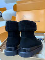 Back view of dark navy high-top boots with shearling cuffs and chunky platform soles