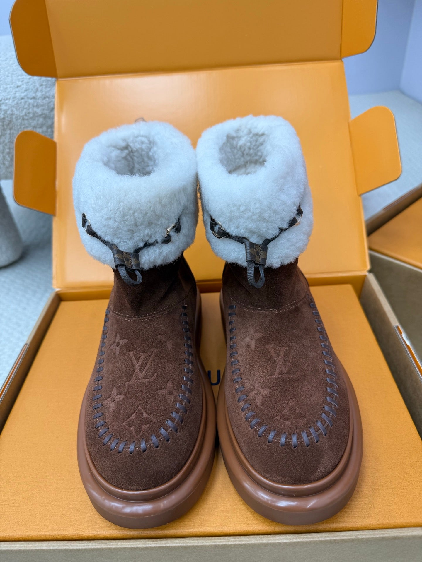 Louis Vuitton ladies shoes with brown suede and light blue shearling, lace tie, platform sole.