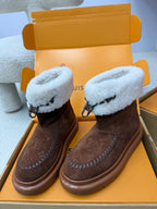 Louis Vuitton ladies shoes with brown suede and light blue shearling cuffs, tied bow and rubber sole.