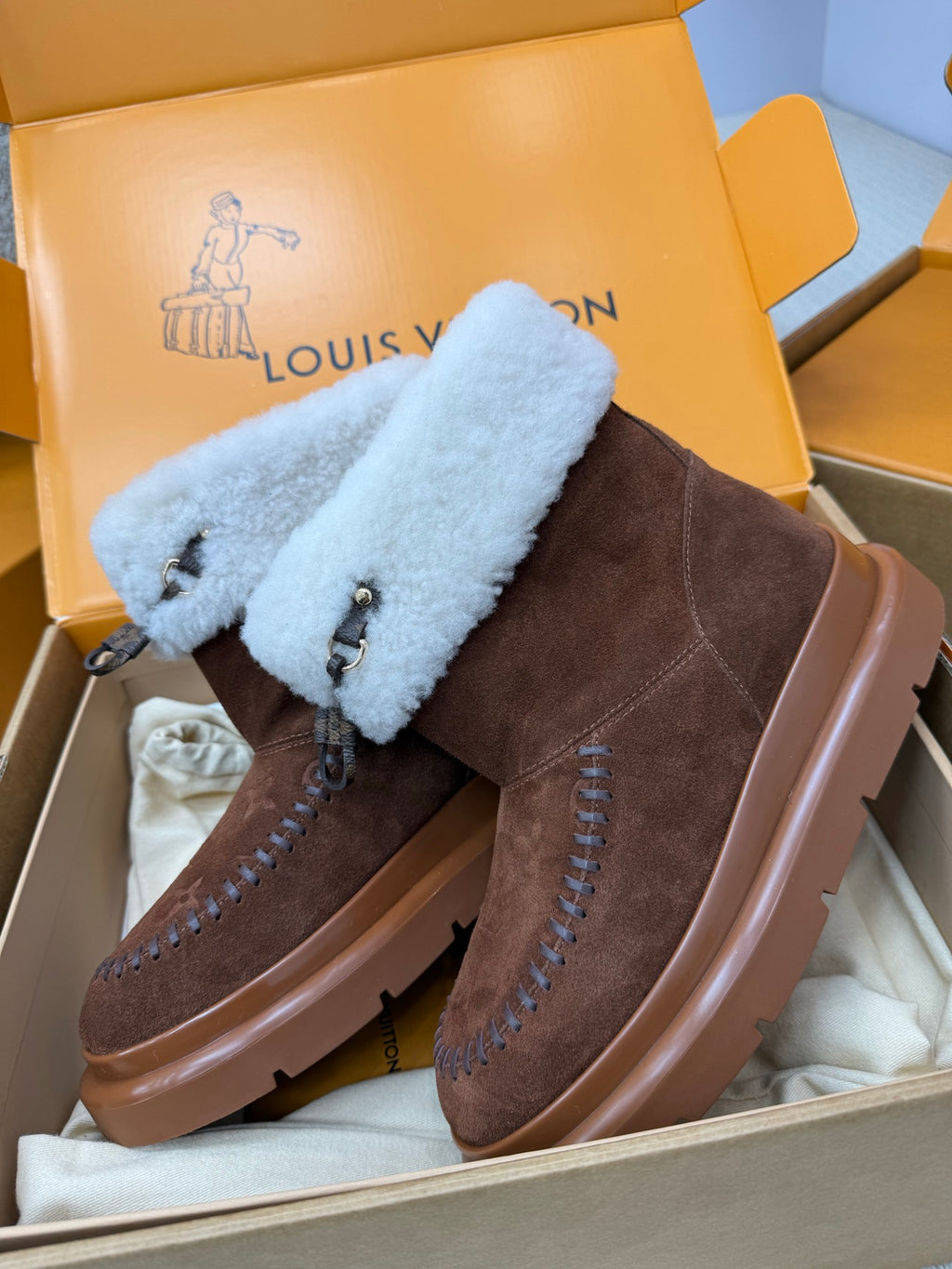Louis Vuitton ladies shoes with brown suede, light blue shearling strap cuffs, platform rubber sole.