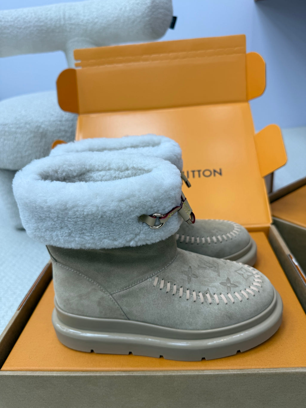 Louis Vuitton women's gray suede boots with light blue shearling cuff, side stitching, and strap