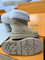 Louis Vuitton women's gray suede boot with light blue shearling cuff and visible outsole