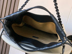 Loewe bag interior with cream lining and black leather top handles