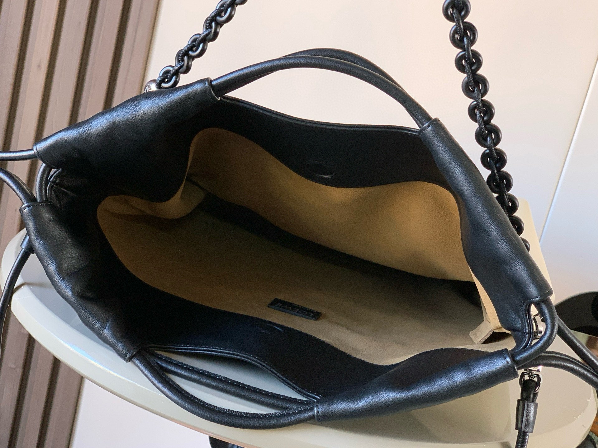 Loewe bag interior with cream lining and black leather top handles