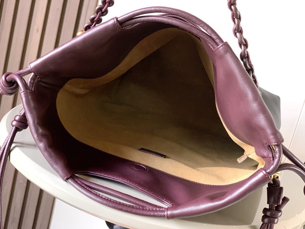 Dark leather drawstring bag interior view with gathered top and cord ties
