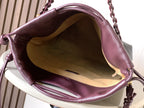 Dark leather drawstring bag interior view with gathered top and cord ties
