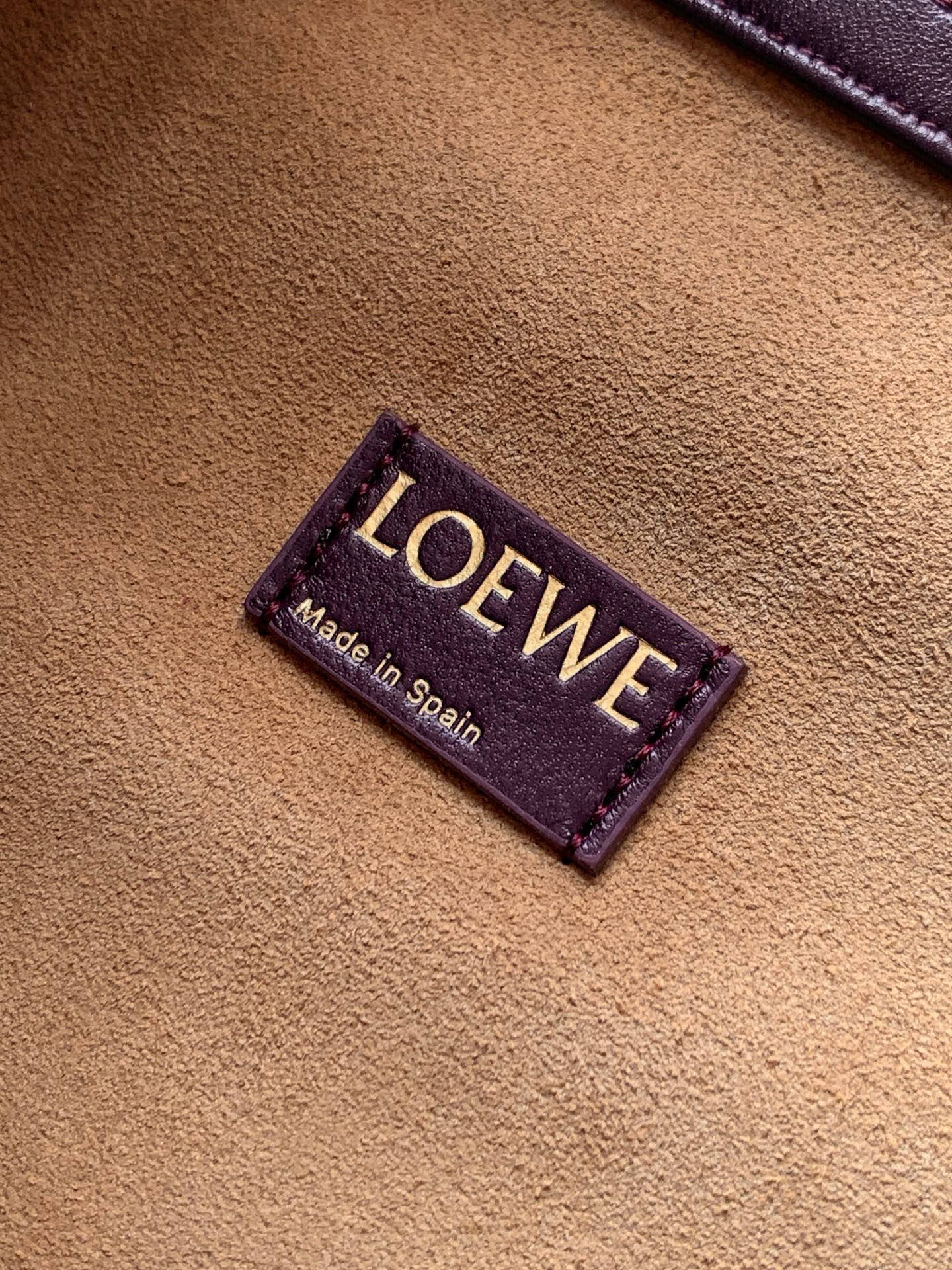 Leather bag close-up of “LOEWE” brand patch with “Made in Spain” text