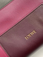 Leather bag panel close-up with pink and taupe leather and Loewe lettering
