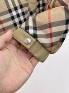 Burberry long jacket cuff detail with beige tab and snap button on plaid
