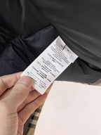 Long dark garment fabric with white care label tag