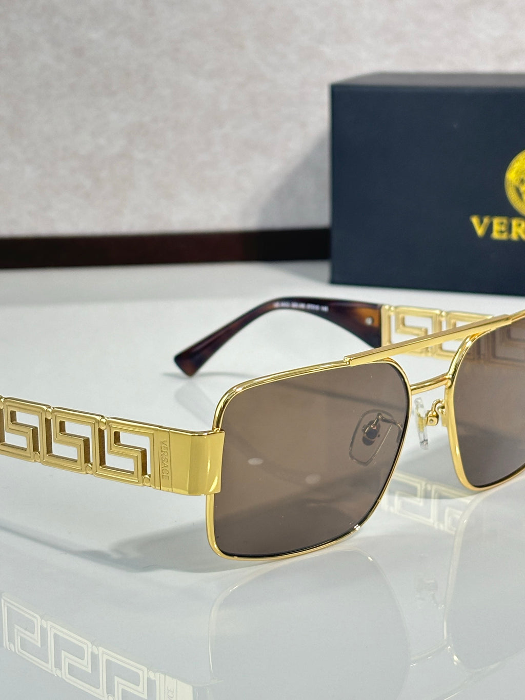 Sunglasses with gold-tone frames and brown lenses, Greek key temple pattern
