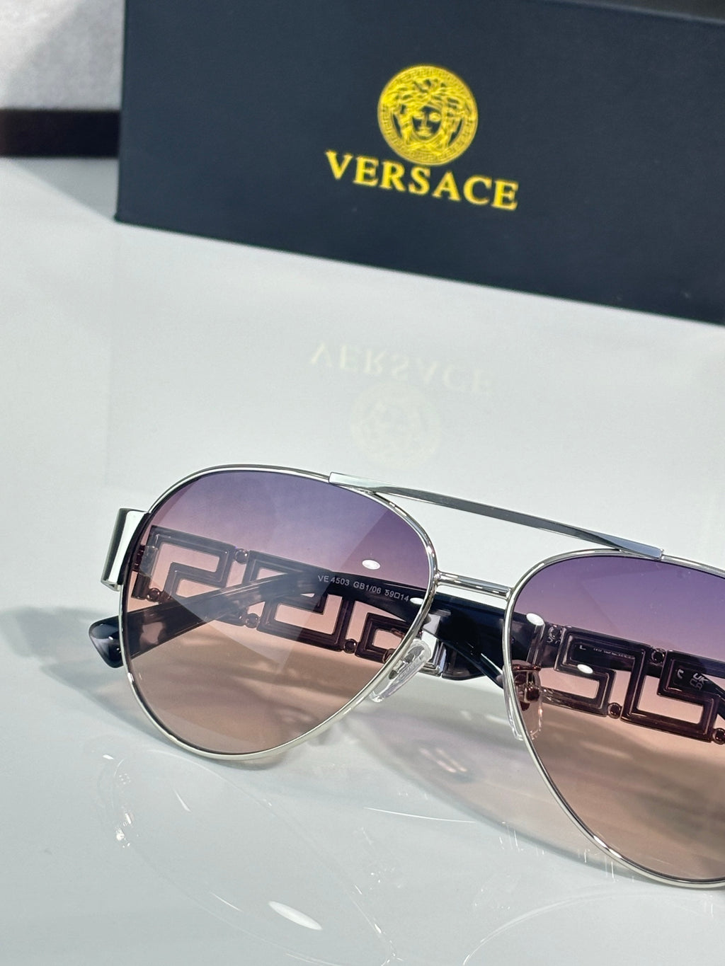 Versace round aviator sunglasses with purple tint and silver frame