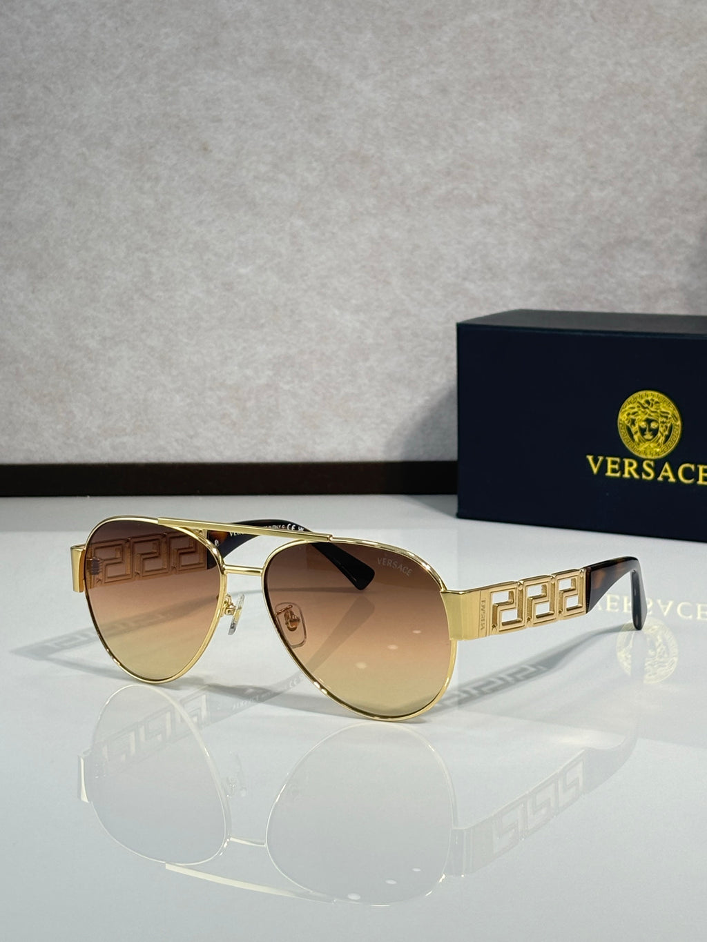 Versace aviator sunglasses with gold frame and amber tinted lenses