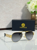 Versace aviator sunglasses with dark lenses and gold frame with logo block temple