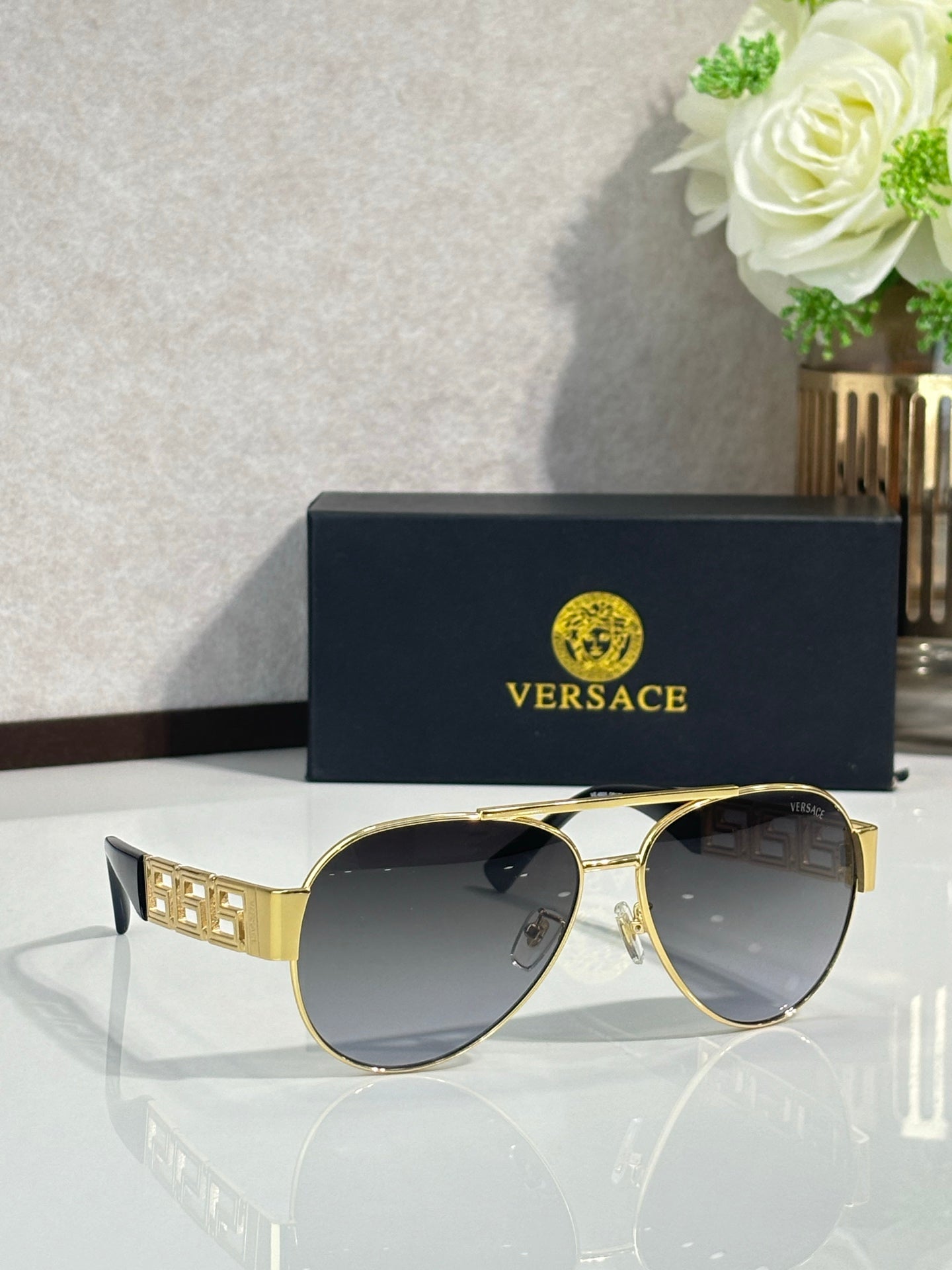 Versace aviator sunglasses with dark lenses and gold frame with logo block temple