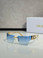 Dior sunglasses with gold frame and light blue lenses, front three-quarter view.