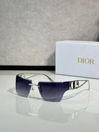 Dior sunglasses with gold frame and deep blue lenses, front three-quarter view.
