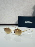 Gold-tone round sunglasses with amber tinted lenses and thin metal arms