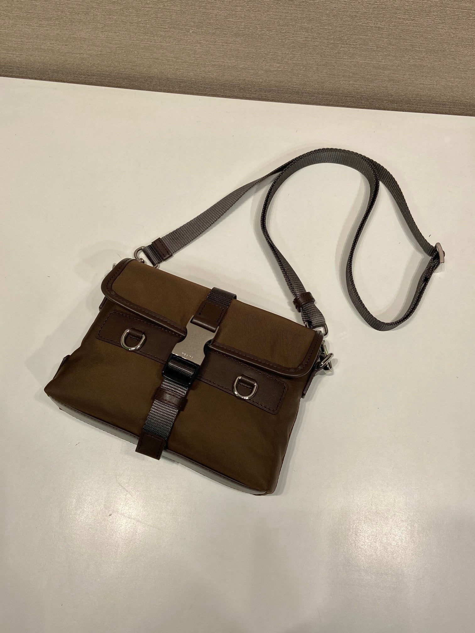 Prada dark brown nylon mini crossbody bag with two front buckled straps