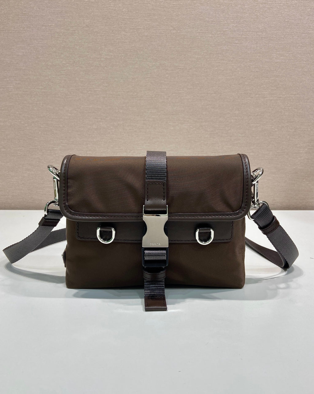 Prada nylon shoulder bag in dark brown with flap and buckled crossbody strap
