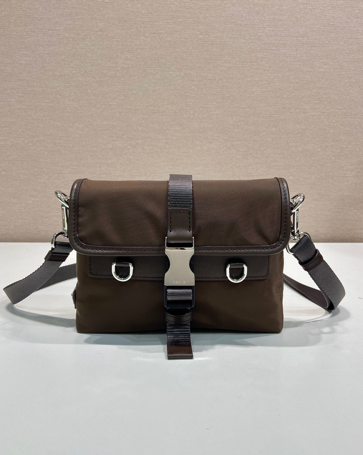 Prada nylon shoulder bag in dark brown with flap and buckled crossbody strap