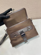 Prada brown nylon bag with front clasp, D-ring details, and adjustable strap