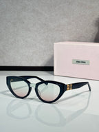 Cat-eye sunglasses with dark tortoiseshell frames and clear temple tips, tinted lenses