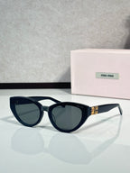 Cat-eye sunglasses with dark tortoiseshell frames, tinted lenses, clear temple tips