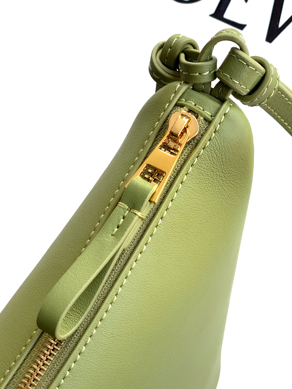 Loewe lime green leather bag close-up showing gold-tone zipper and front zipper pocket