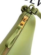 Loewe lime green leather bag close-up showing gold-tone zipper and front zipper pocket