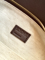 Beige fabric pouch inside with dark brown LOEWE logo label and gold zipper
