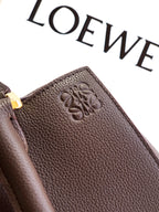 Dark brown leather bag strap end with embossed LOEWE logo patch