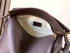 Dark brown leather bag interior with beige lining and LOEWE label