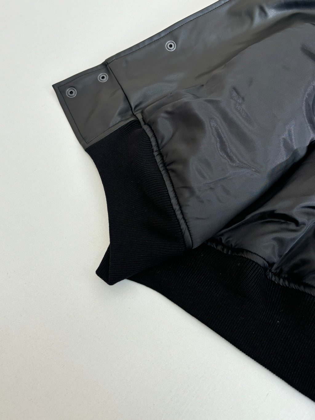 Balenciaga long jacket sleeve hem, dark button tabs and ribbed cuff