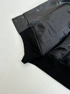 Balenciaga long jacket sleeve hem, dark button tabs and ribbed cuff