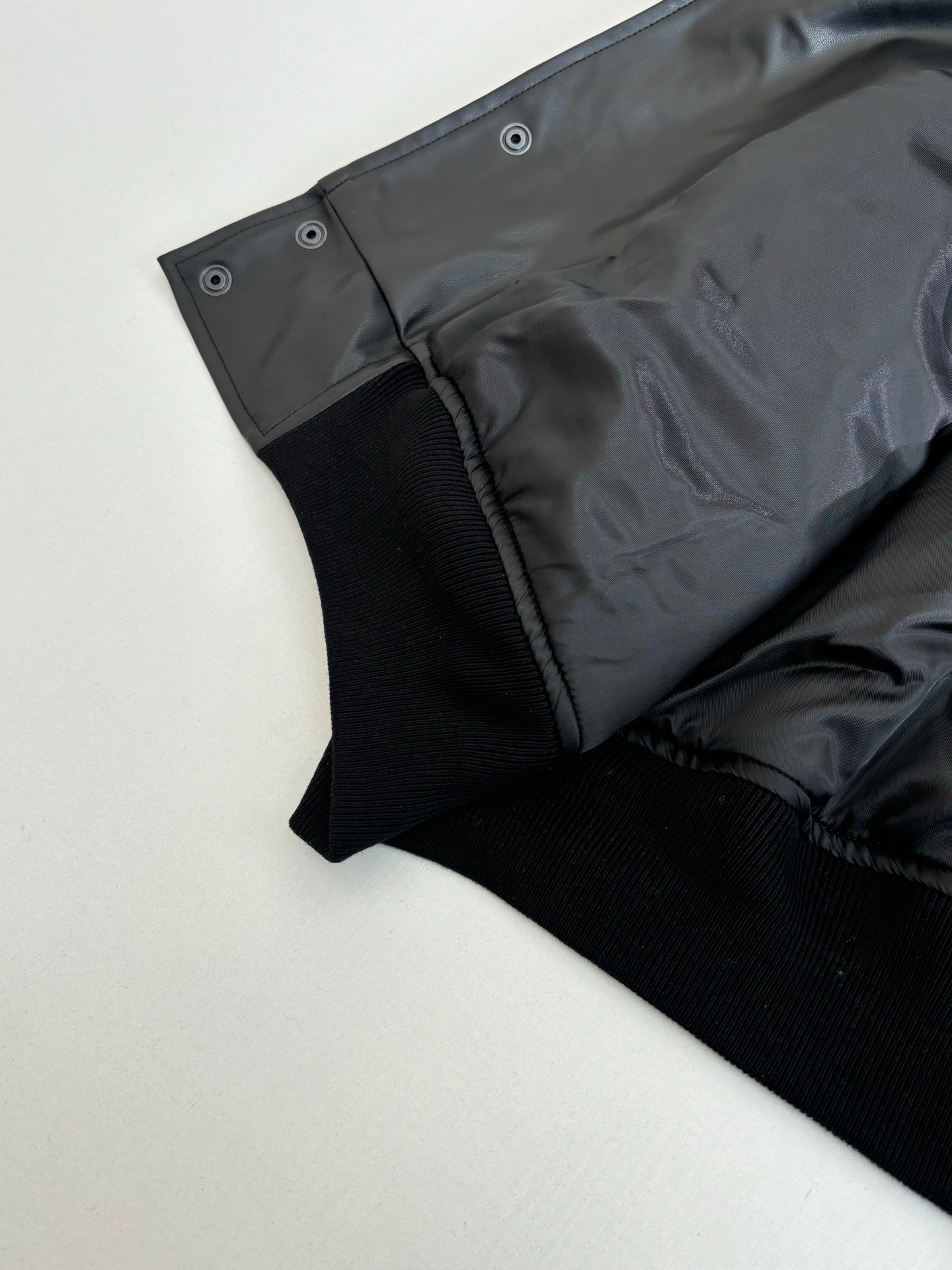 Balenciaga long jacket sleeve hem, dark button tabs and ribbed cuff