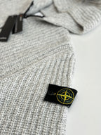 Stone Island knit hoodie chest label on light gray ribbed knit with black zipper trim