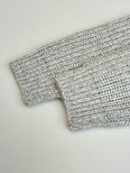 Stone Island knit fabric close-up with light gray ribbed cuff and hem detail