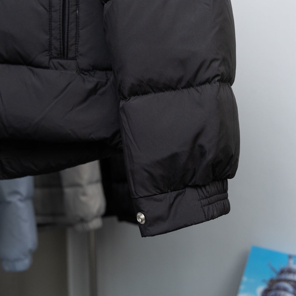 Long puffer coat sleeve and hem with snap button detail