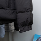 Long puffer coat sleeve and hem with snap button detail