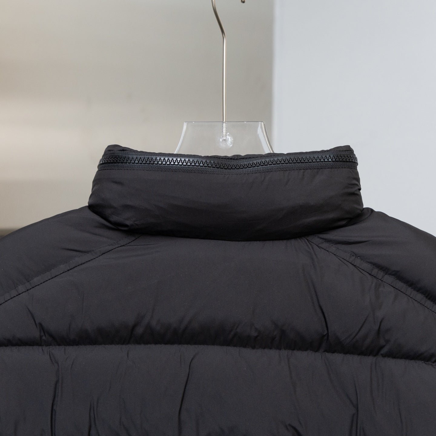 Black long puffer jacket high collar with ribbed trim and stitched edge