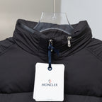 Black puffer jacket with stand collar, front zipper and MONCLER hang tag