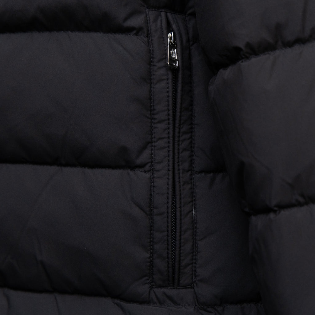 Black quilted puffer jacket front panel with centered zipper and stitched seams