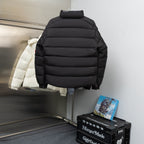 Black long puffer jacket with hood and horizontal quilting, no visible branding