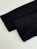 Dark jacket fabric cuff and sleeve hem with stitched seams