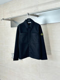 Dark button-up jacket with chest pockets and Stone Island logo patch on sleeve