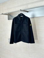 Dark button-up jacket with chest pockets and Stone Island logo patch on sleeve