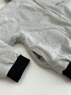 Heather gray zip-up hoodie sleeve and hood with black ribbed cuff