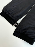 Black zip-up hoodie with textured fabric and silver zipper