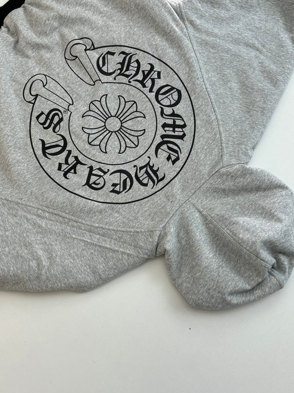 Gray hoodie with large black circular front graphic and long sleeves